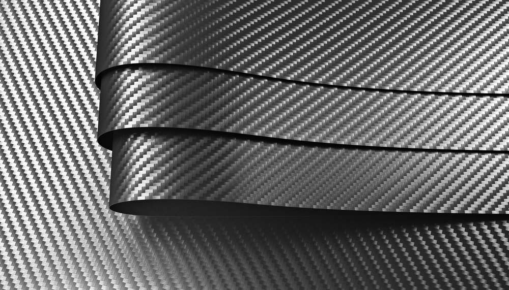 Close-up of carbon fiber texture with three curved, overlapping ribbons.