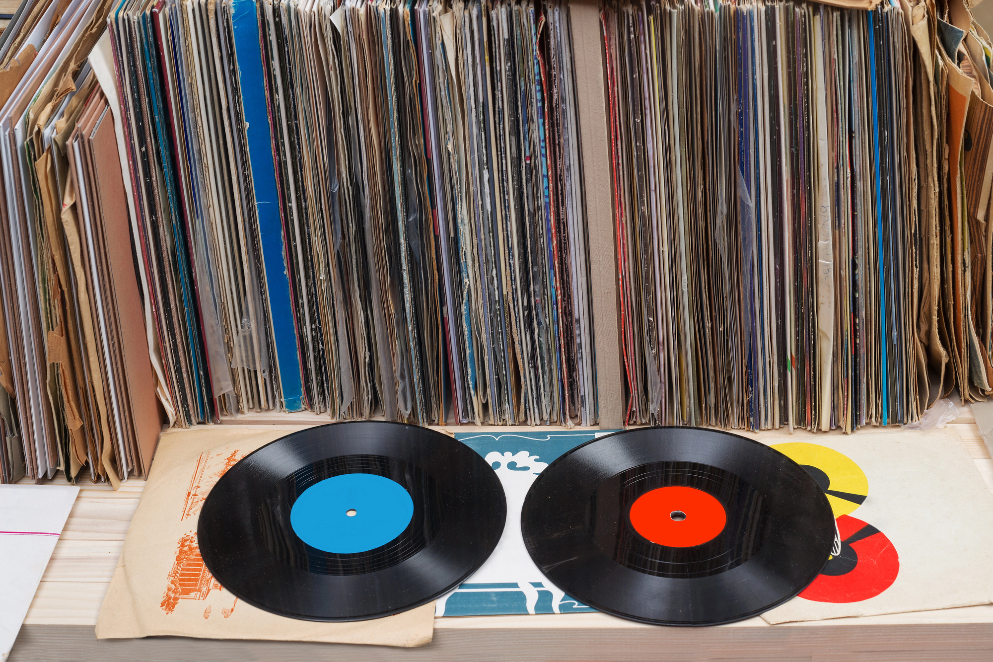 Vinyl records representing Australia's ARIA decision to ban fully AI-generated music from official music charts