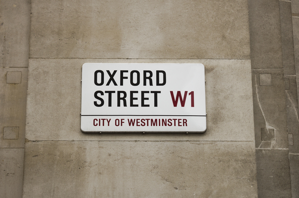 Street sign reading Oxford Street W1, City of Westminster, mounted on a stone wall.