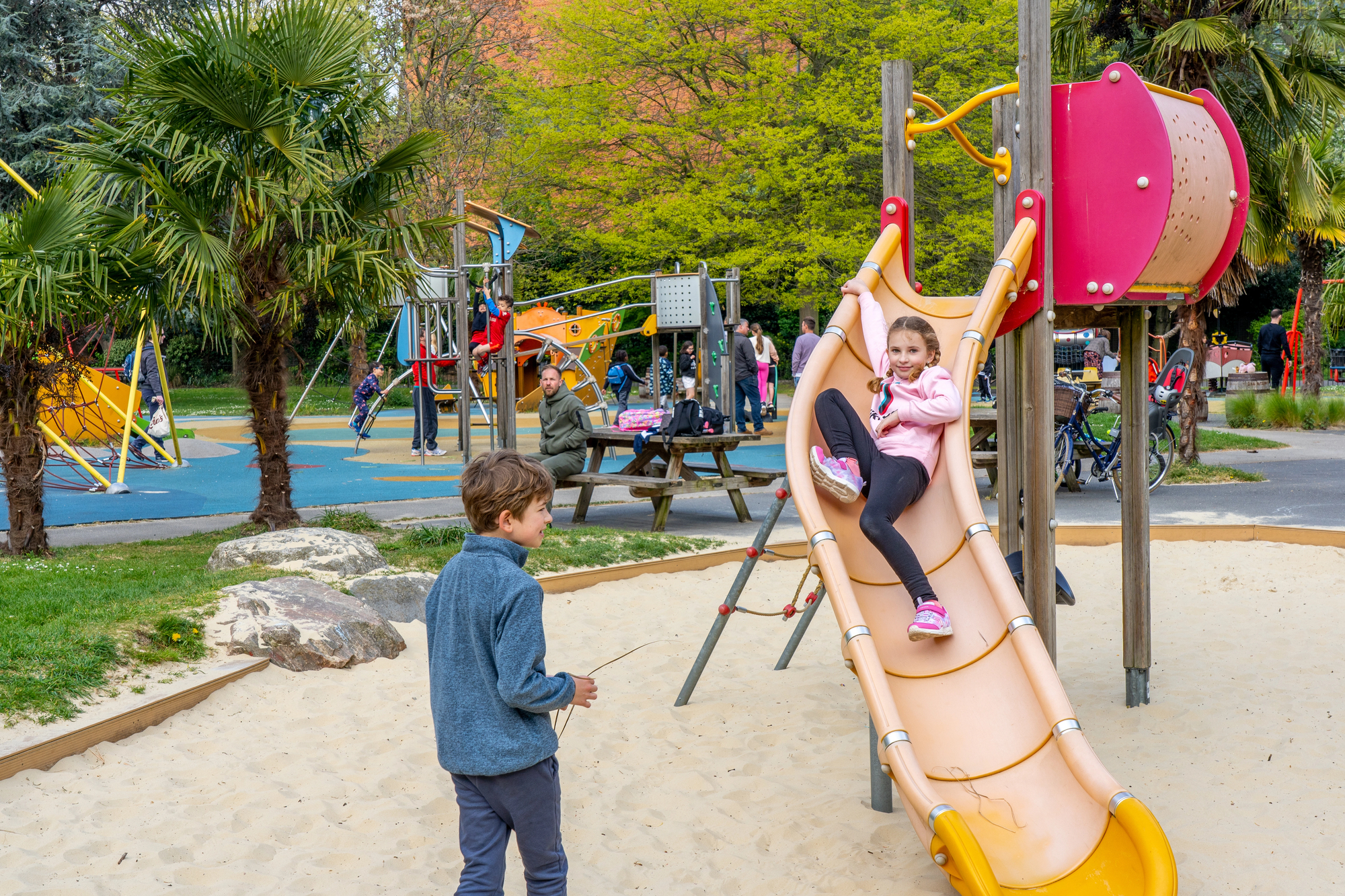 Children playing outdoors in London with reduced traffic in the background, illustrating new research linking cleaner air to better lung development in children