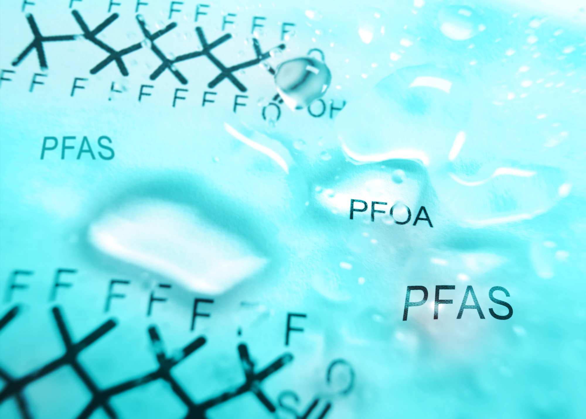 Close-up of a PFAS chemical structure diagram with bold letters PFAS on a blue background.