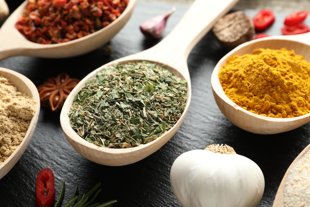 Immune-supporting herbs and spices on a wooden kitchen surface
