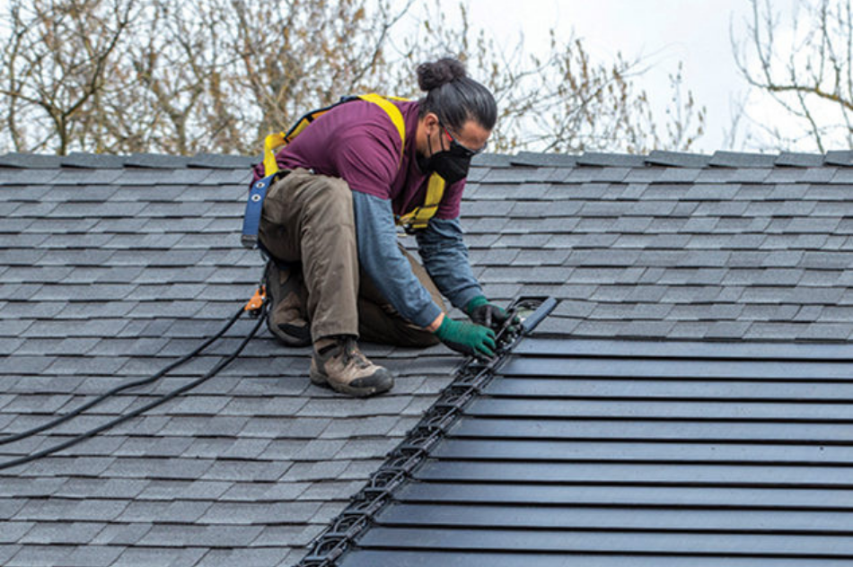 Worker installing a GAF solar roof