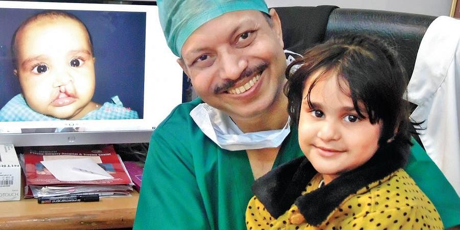 Dr. Subodh Kumar Singh with cleft-lip/palate surgery patient post-operation
