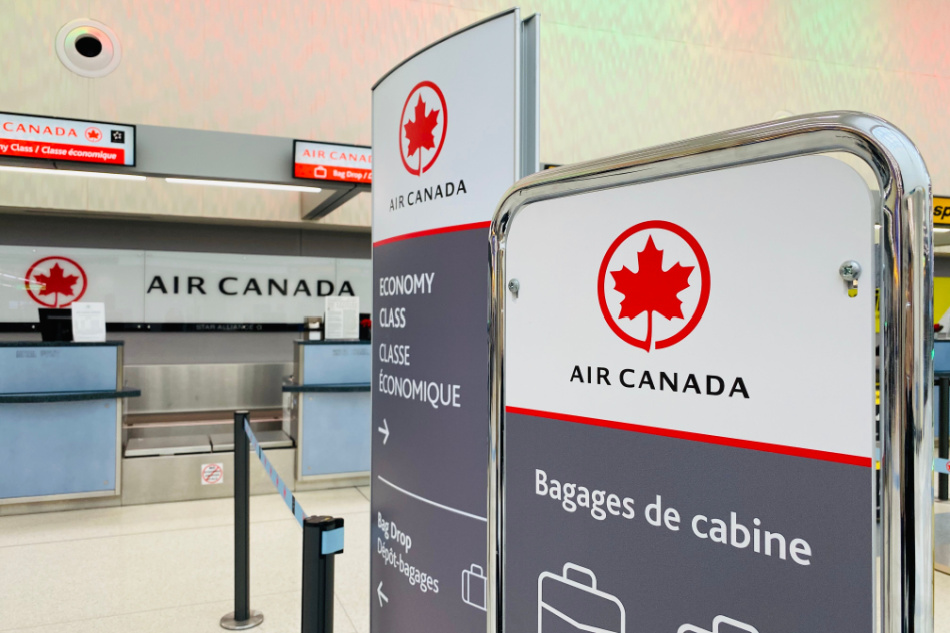  Air Canada baggage weighing with check in counter in the background.