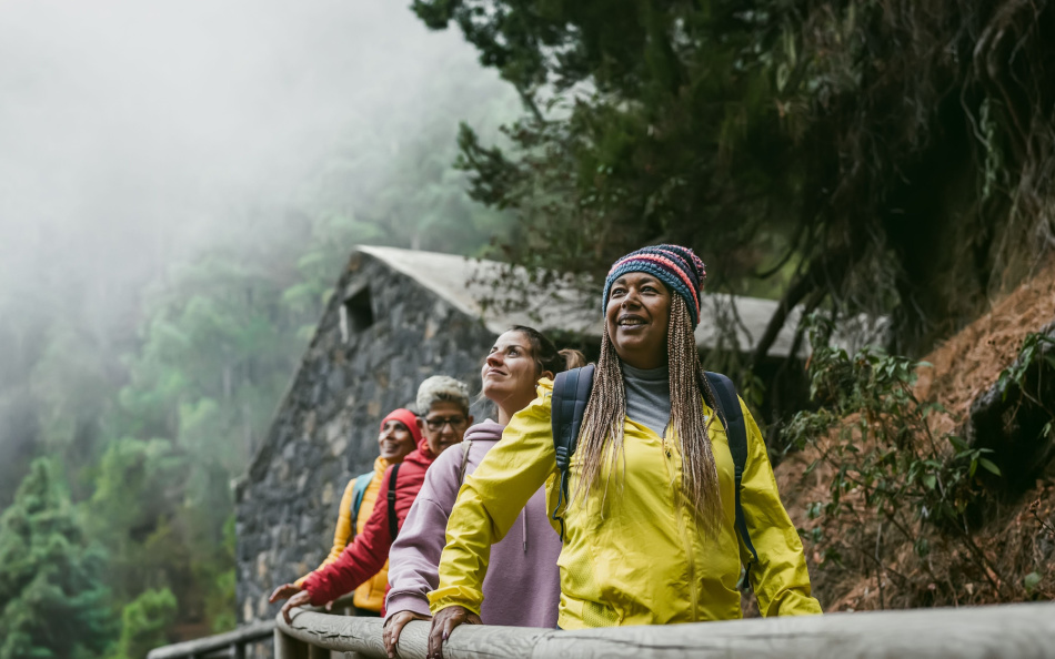 Group of women with different ages and ethnicities having fun walking in the woods - Adventure and travel people concept