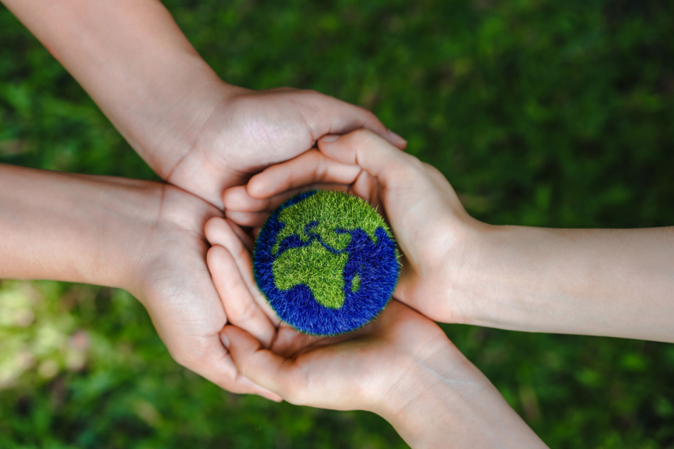 hands holding the earth on a green background to protect nature Save and care World for sustainable. concept of the environment ecology and Earth Day