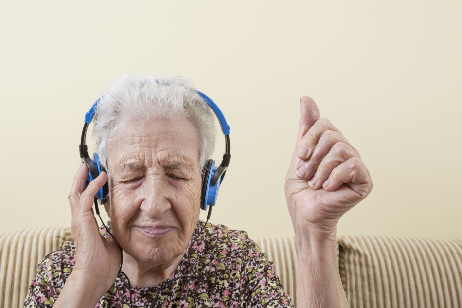 elderly woman listening music in headphones