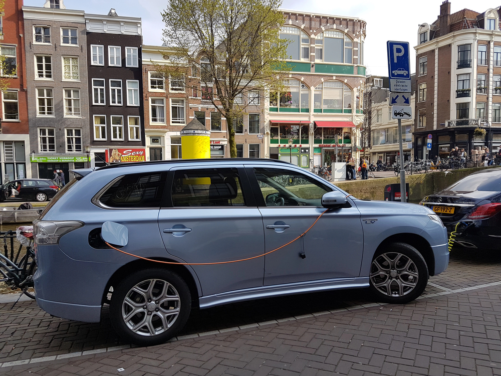 Electric vehicle charging at a European charging station as oil prices rise during the Iran energy crisis
