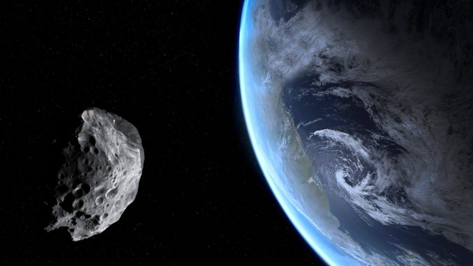 Asteroid in the forefront and earth in the background.