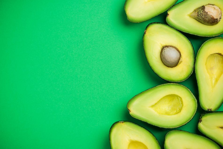 Avocado on bright green background,creative food concept.
