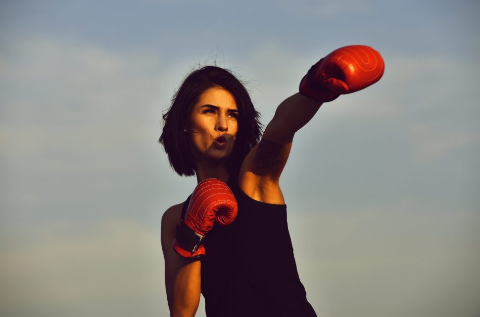 Strong looking young woman boxes the air