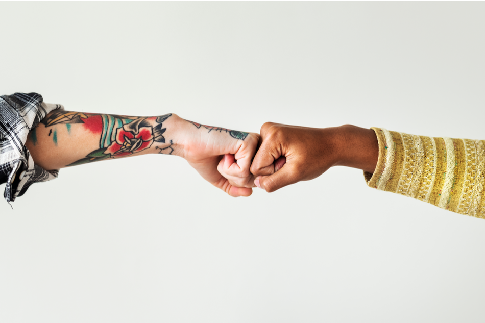 two diverse hands fist bump