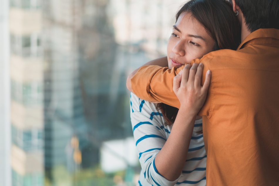 Young depressed asian woman hug her friend for encouragement.
