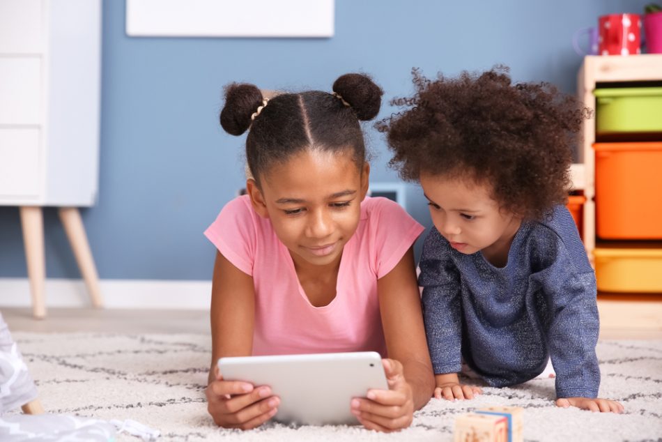 Two young girls looking at an iPad