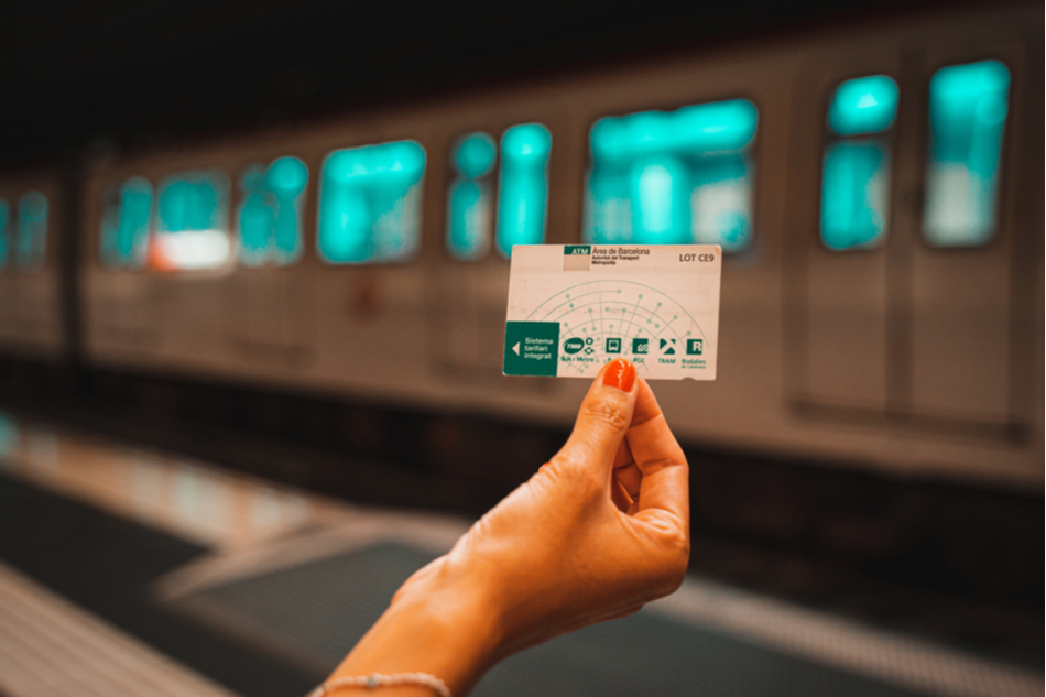 Woman holding metro travel pass