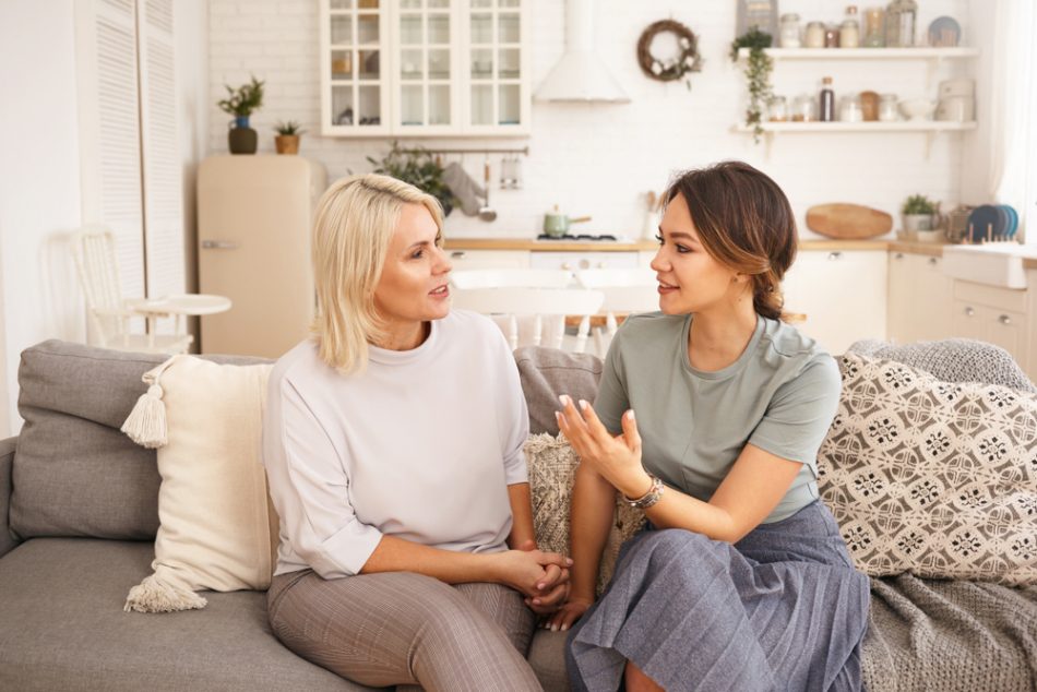 Two women discussing something on the couch