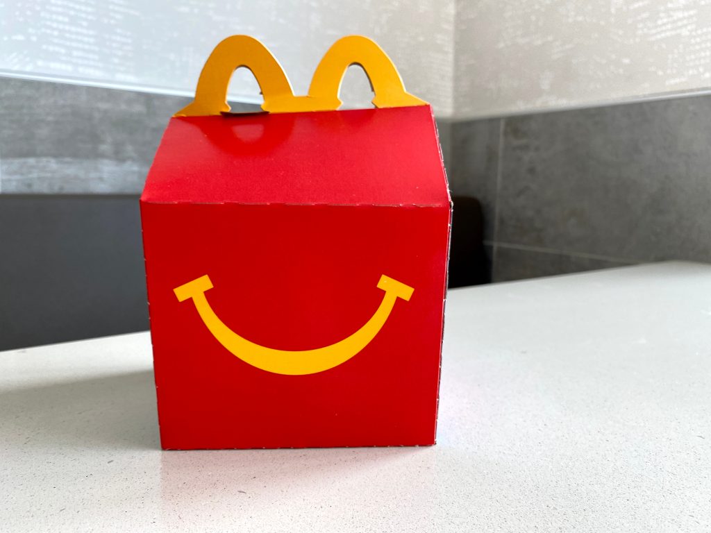McDonald's Happy Meal box sits on white table