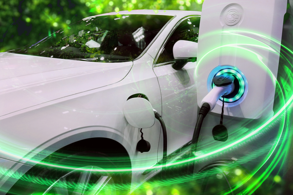 EV Car or Electric vehicle at charging station with the power cable supply plugged in on blurred nature with green enegy power effect.