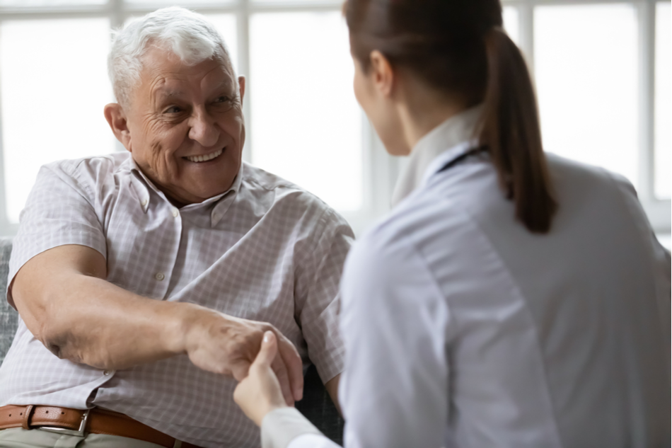 Doctor delivering good news to happy elderly patient