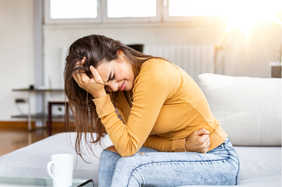 young woman suffering from severe period pain