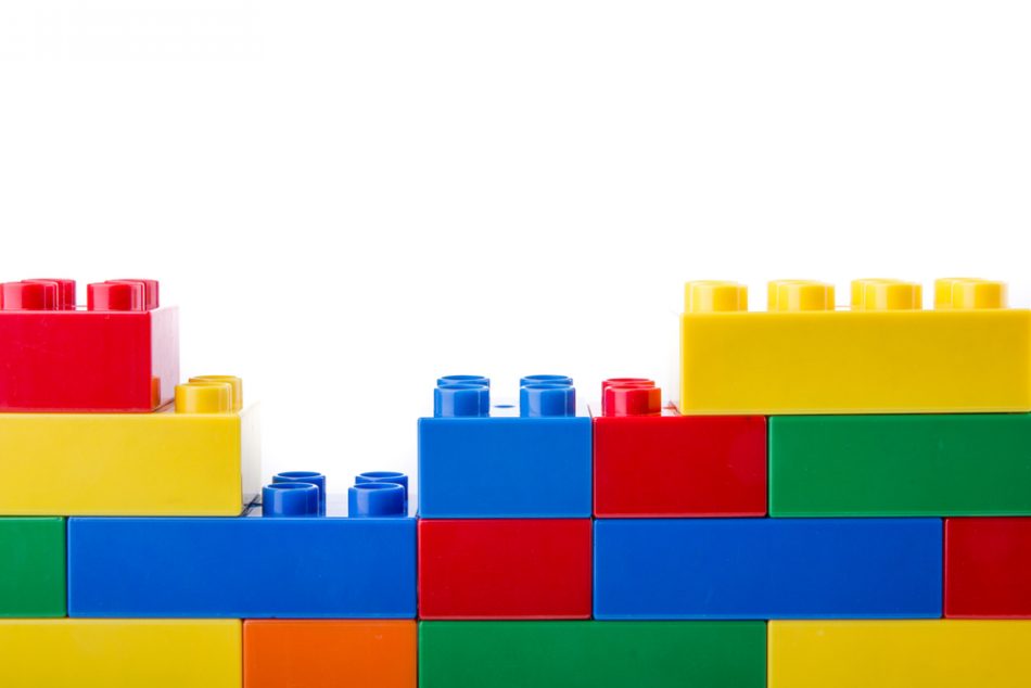 Plastic, colorful lego building blocks isolated on white background.