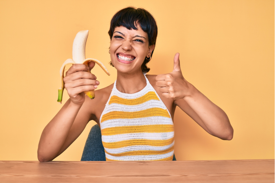 young happy woman with banana