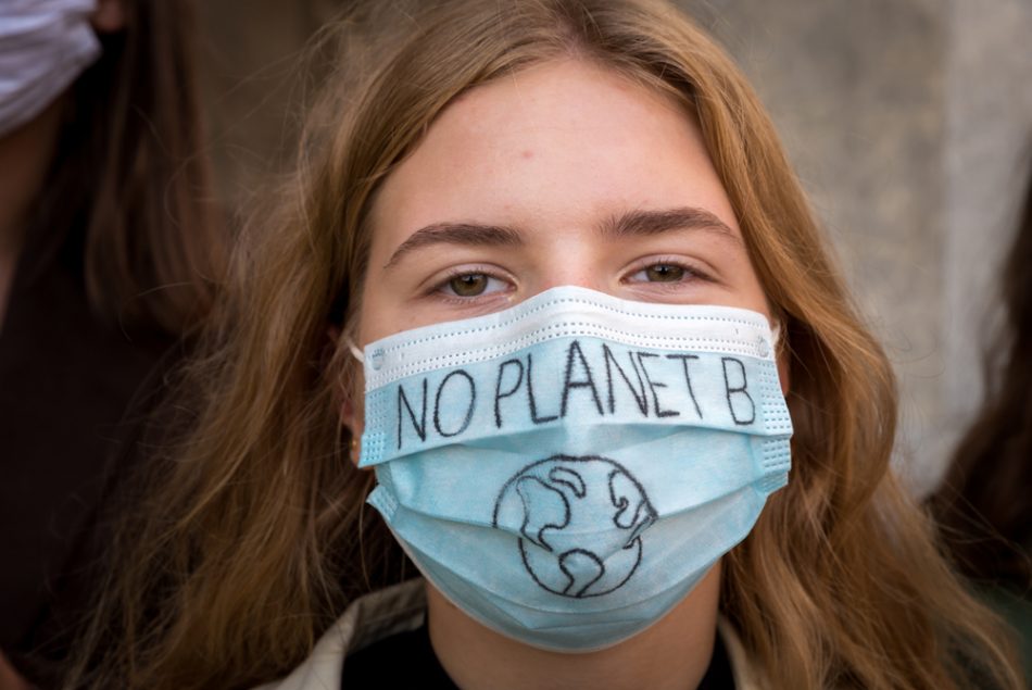 Portrait of a girl wearing face protective mask at Youth strike for climate in protest of climate change policy.