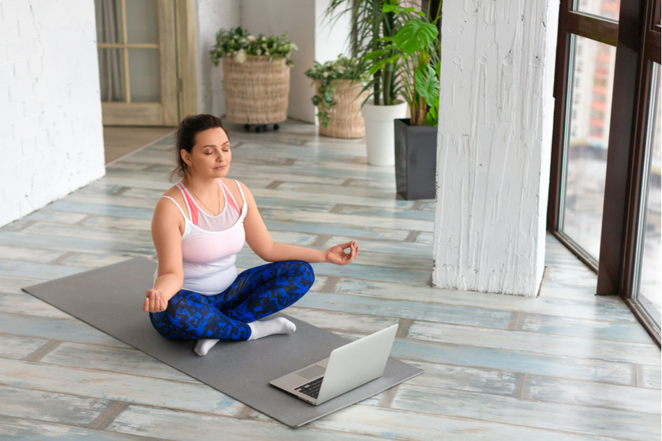 Woman meditating on yoga mat