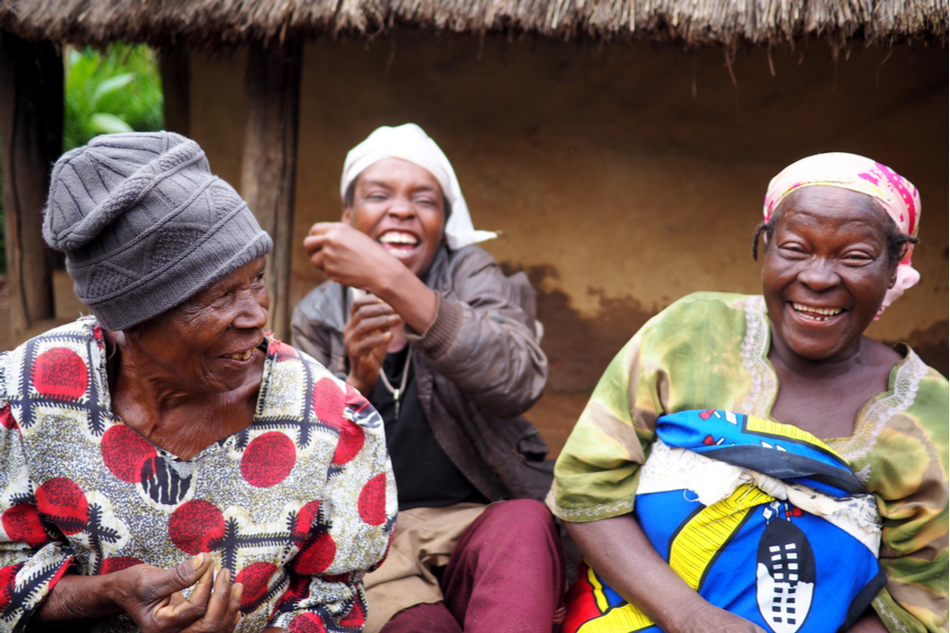 three happy Zimbabwean women in their village
