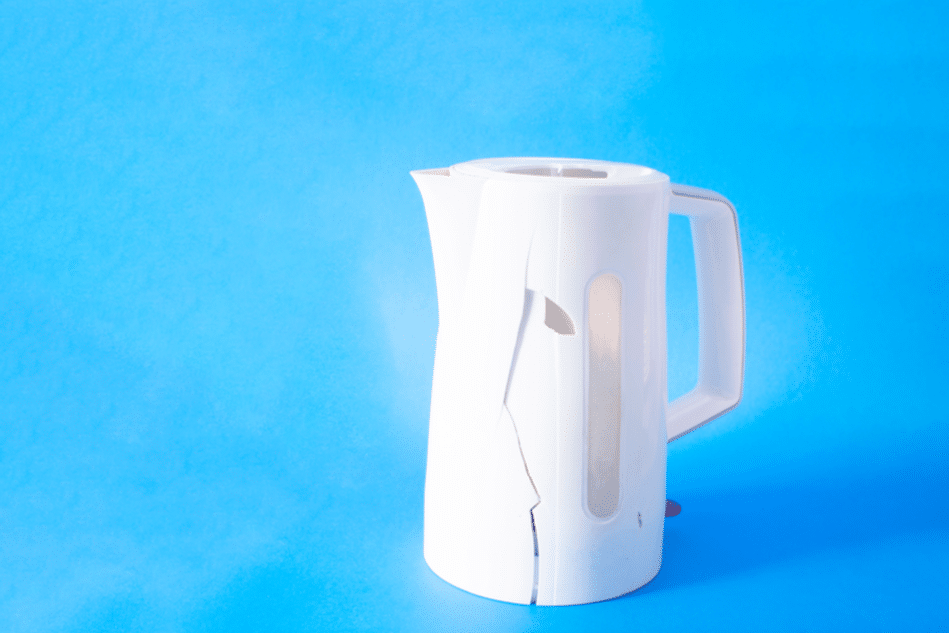 Broken plastic electric kettle with crack on the side