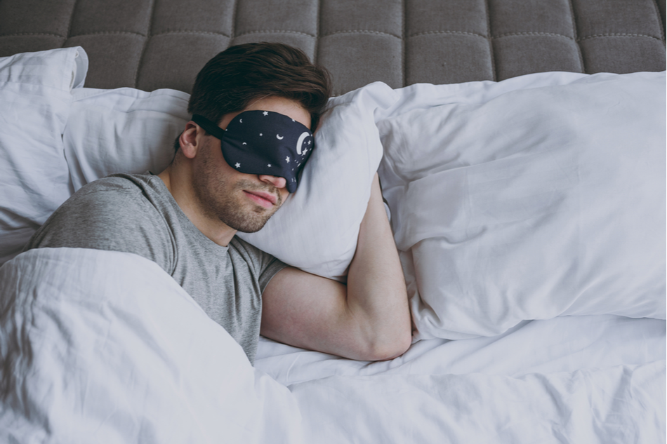 man sleeps with eye mask