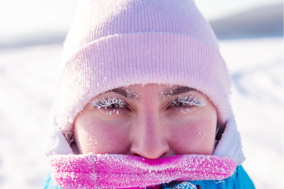 Woman wearing pink hat with frozen eyelashes