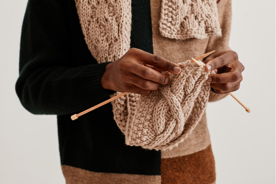 close up of Black man's hands knitting
