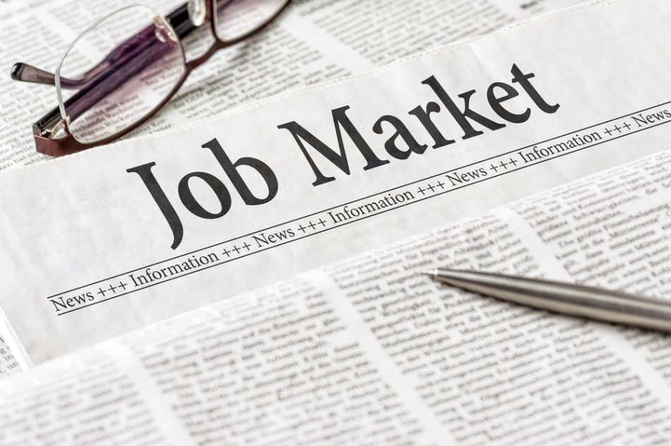 A newspaper with the headline "Job Market."