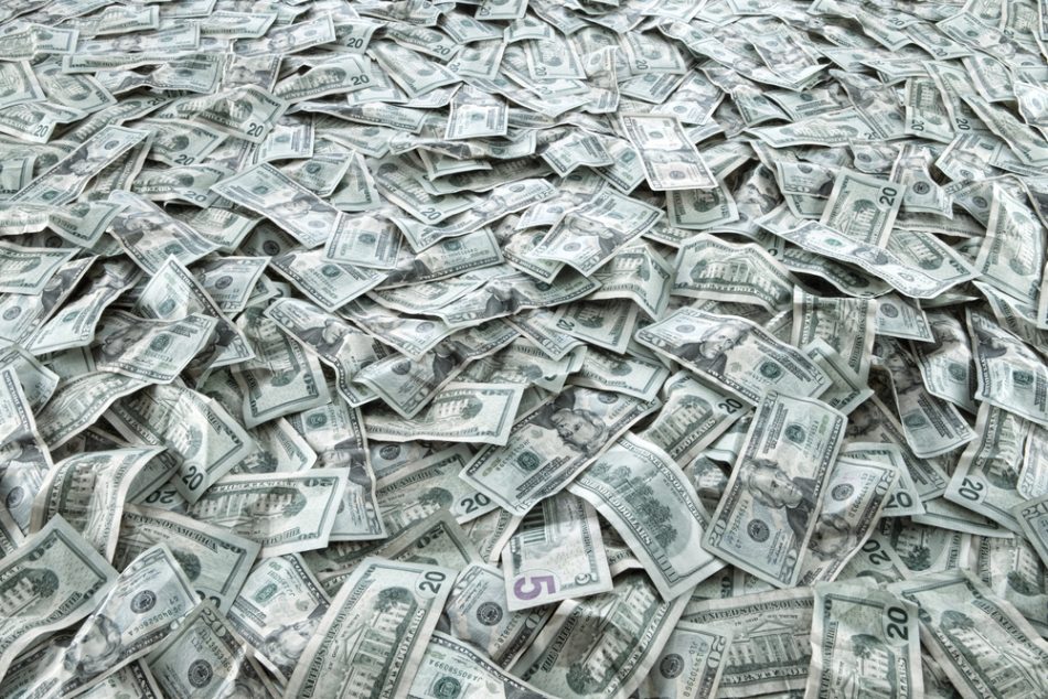 Close up view of cash money dollars bills in amount.