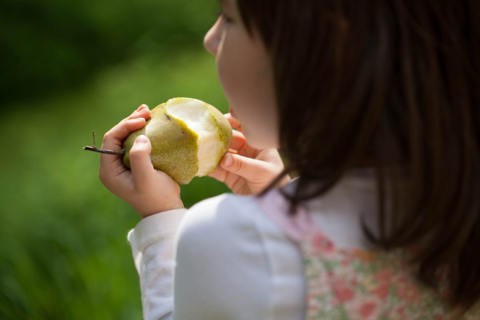 child eating healthy pear