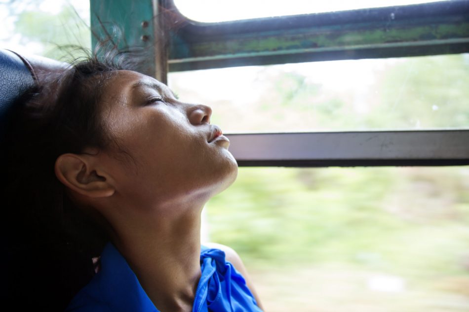 young Asian woman asleep on a bus