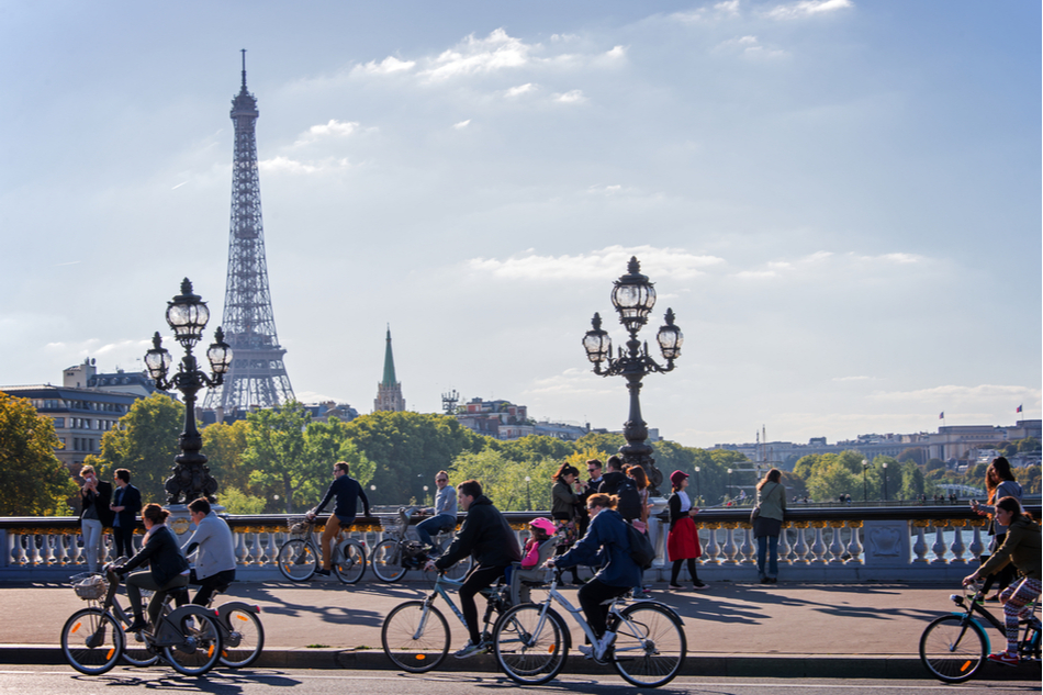 People biking in Paris with Eiffel Tower in the background