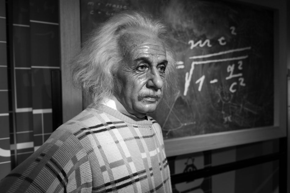 Wax figure of Albert Einstein stood in front of a blackboard with his most famous equation written on, E=mc2