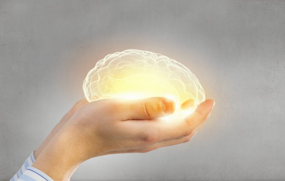 hands holding glowing brain