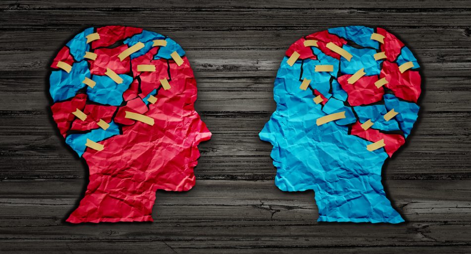 Thinking exchange and idea partnership business communication concept as a red and blue human head cut from crumpled paper as a symbol for understanding political opinions or cultural differences.