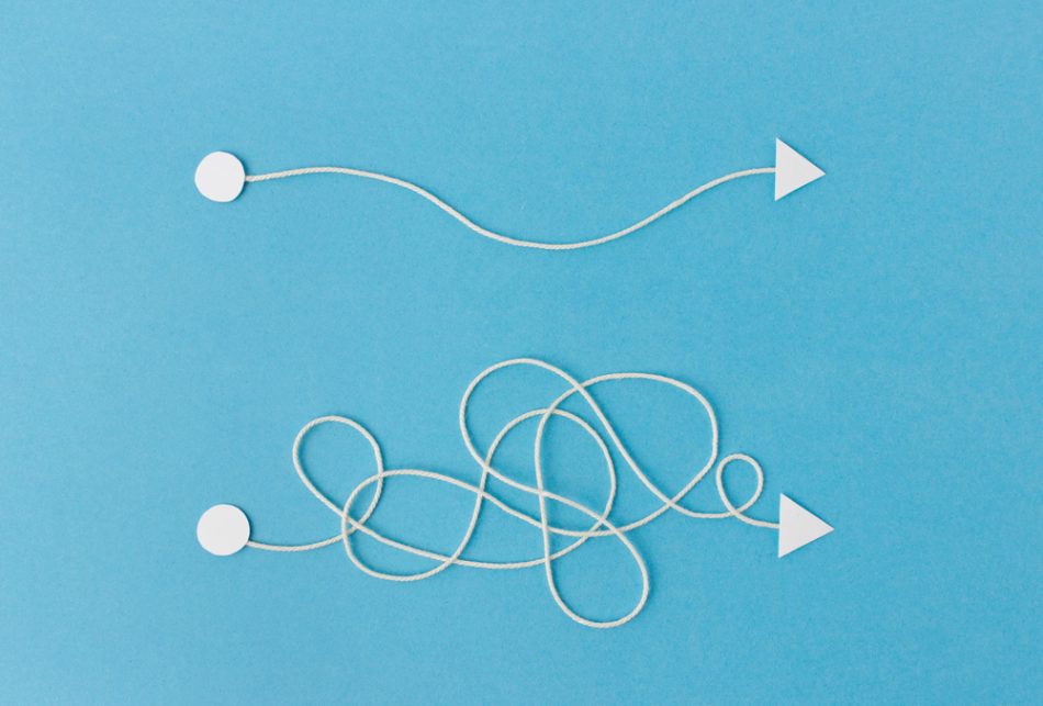 Easy vs complicated concept using white string and arrows over a blue background.