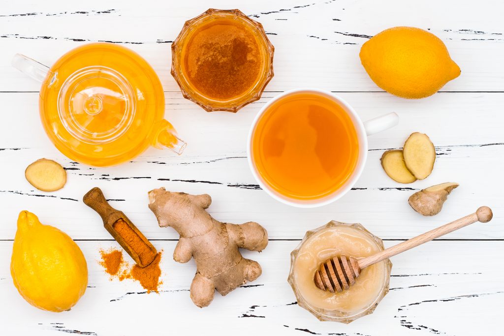 honey ginger turmeric lemon and other ingredients to make a homemade wellness shot