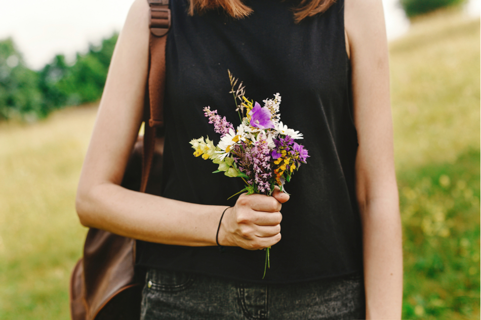 woman holds a bouquet of wildflowers