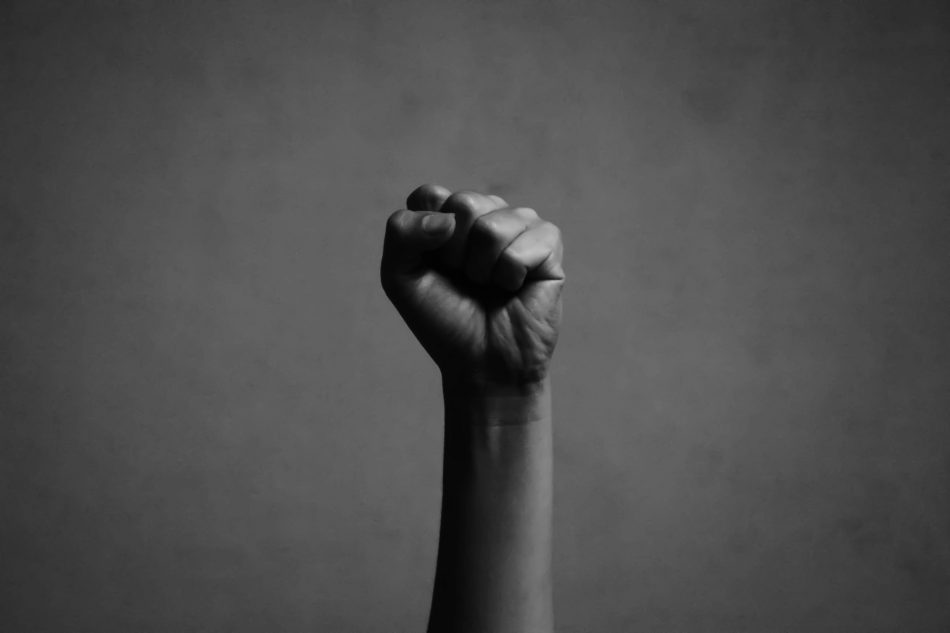 blurry and soft focus of fist raised in the air in white tone