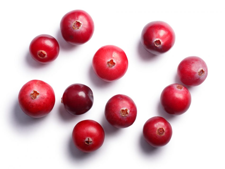 Cranberries scattered on a white background.