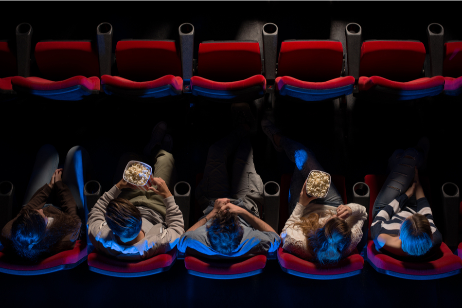 view from above of young people watching movie at cinema