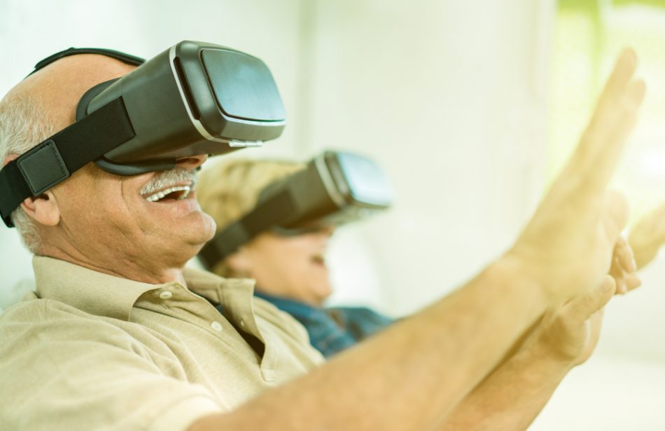 Senior mature couple having fun with virtual reality glasses.