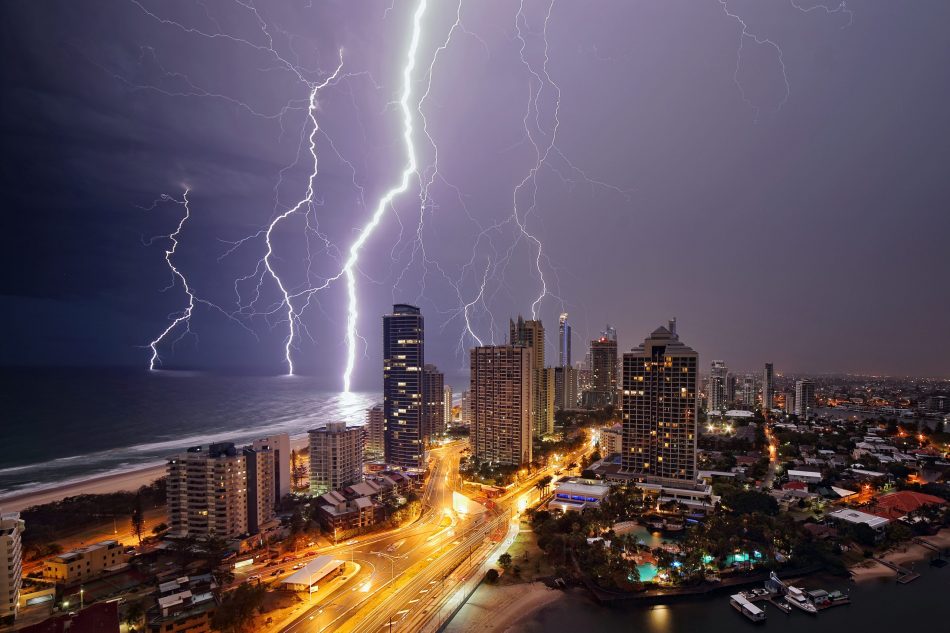 Lightning over sea, city